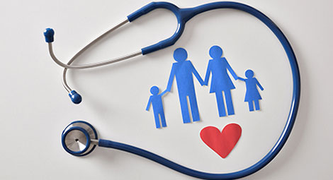 Stethoscope around paper cut outs of a family